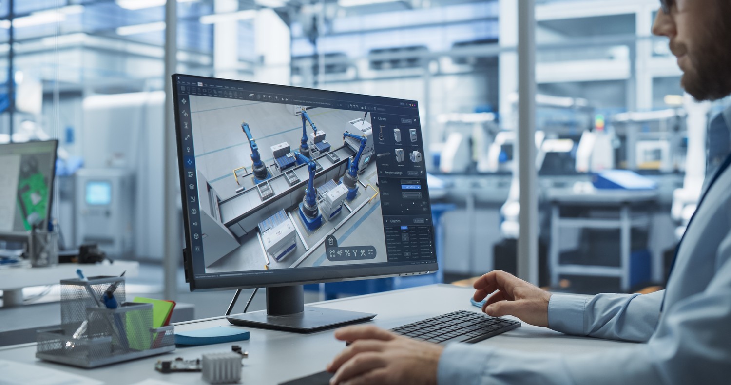 Modelo 3D de una máquina en pantalla, sobre la mesa de un ingeniero